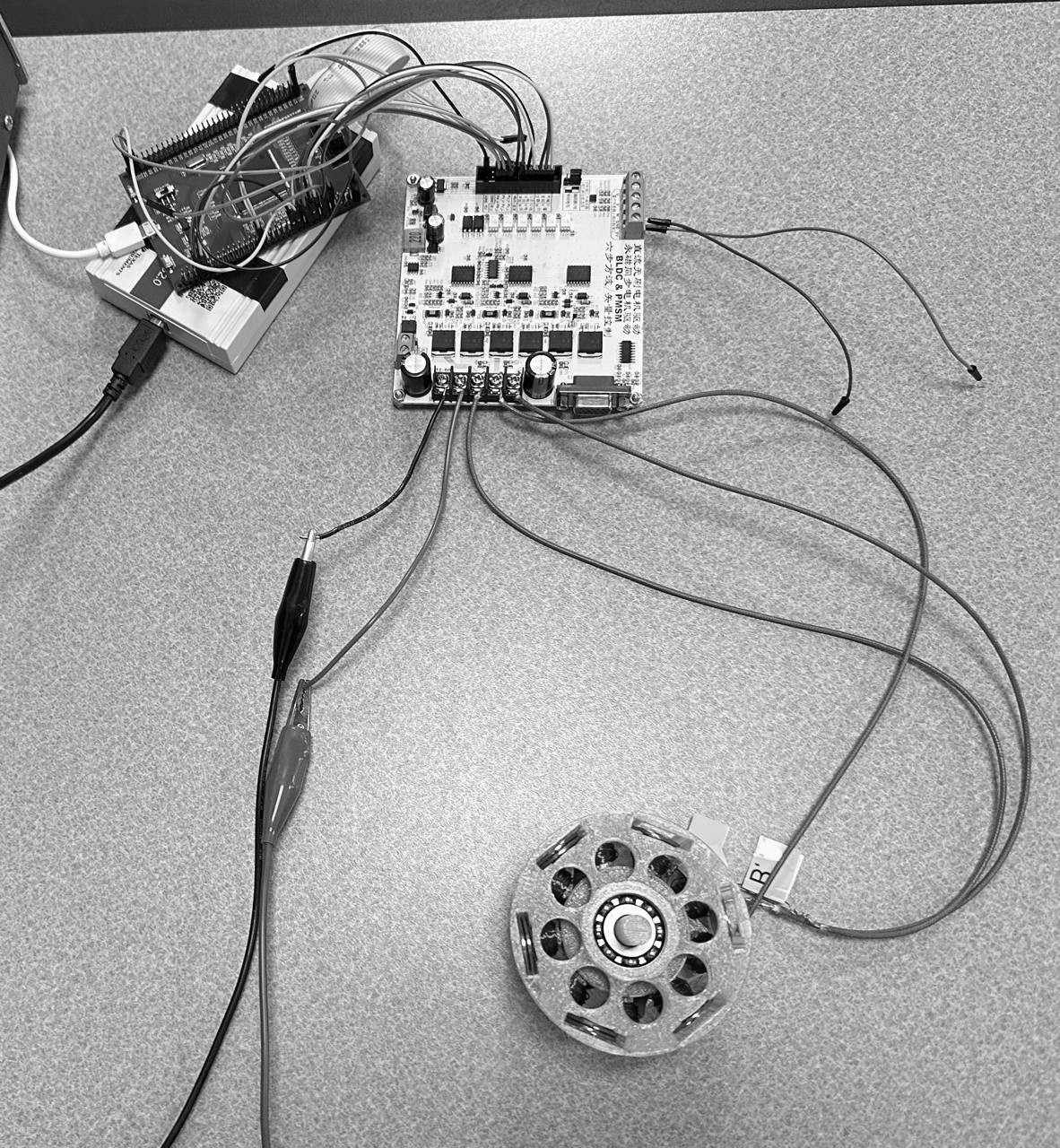 Rev 3 on the bench: the lilac 3D-printed stator wired to the inverter board, which is driven by the DSP board.
